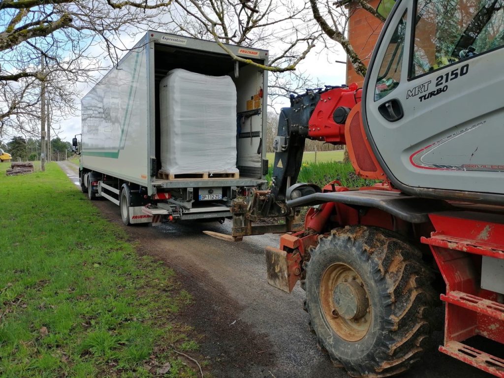 Palette déchargée d'un camion des Transports Gauthier à l'aide d'un manitou lors d'une livraison.